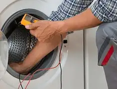 Washing machine repair technician testing a front-load washer with diagnostic tools in Mesa, AZ